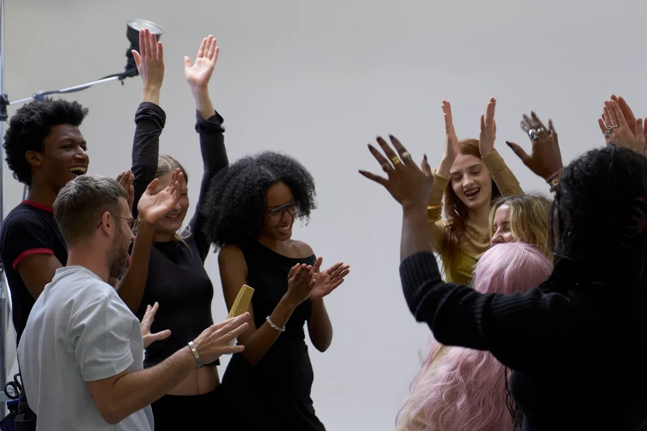 Team celebrating with hands in the air